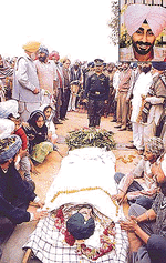 Armymen and villagers pay their last respects to Sepoy Kartar Singh (inset) at his native village, Sayan Kalan, near Ludhiana on Sunday.