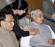 A volunteer pins a symbol of AIDS safety on Prime Minister Atal Behari Vajpayee at a function on World AIDS Day in New Delhi on Friday.