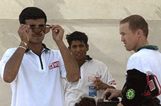 Indian cricket captain Saurav Ganguly (L) checks out the sunglasses of Zimbabwe cricketer Andy Flower (R) as Indian cricketer Shiv Sundar Das looks on during a practice session on the eve of the second one-day match between the two countries in Ahmedabad.