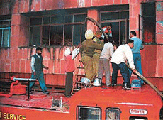 Firemen try to control the fire that broke out in the office of the Municipal Corporation in Sector 17, Chandigarh, on Tuesday. 