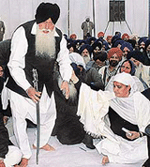 Bibi Jagir Kaur helps SGPC chief Jagdev Singh Talwandi as he gets up to address the gathering at the bhog ceremony in SAS Nagar on Friday.