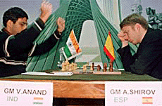 Indian grandmaster Viswanathan Anand (L) raises his hands in celebration after an error by Spain's Alexei Shirov on Sunday in Tehran.