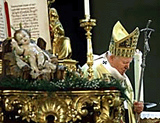 Pope John Paul II walks past a statue of baby Jesus as he arrives to preside over the Midnight Mass at St. Peter's Square in Rome on Xmas-eve.