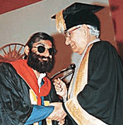 Pradeep Kumar, a blind student, is congratulated by the Panjab University Chancellor, Mr Krishan Kant, after being awarded a degree at the 50th convocation of the university in Chandigarh on Wednesday.