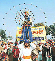 A nihang plays the �gatka� at the Shaheedi Jor Mela in Fatehgarh Sahib.