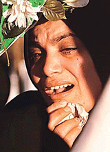 A Palestinian woman cries at a Gaza cemetery on the first day of the four-day Id-ul-Fitr ending the month of Ramzan.