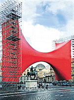 People stand under an art work by Anish Kapoor, born in Mumbai, at Naples Central Plebiscito square on Friday.