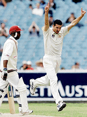 Australia's Jason Gillespie (right) celebrates taking the wicket of West Indies batsman Sherwin Campbell (left) for six runs during the fourth day's play of the fourth Test on Friday.