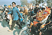Renowned magician Shankar rides a motor cycle blindfolded on the busy Chandigarh-Ambala highway at Dera Bassi .