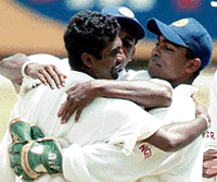 Sri Lankan spin bowler Muttiah Muralitharan (left) is congratulated by wicketkeeper Romesh Kaluwitharne (right) after taking his 300th Test wicket on the final day of the Test agianst South Africa in Durban on Saturday.