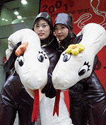 South Korean models pose with toy snakes while promoting a Seoul department store ahead of the approaching Year of the Snake on Sunday.