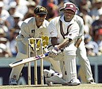 Brian Lara from the West Indies plays a sweep shot as Australia's wicketkeeper Adam Gilchrist looks on during the fifth cricket Test at the Sydney Cricket Ground on Tuesday.