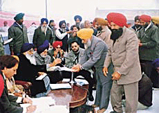 The Punjab Chief Minister distributes grants to panchayat members during a sangat darshan at Kumbhkalan village in Ludhiana district on Tuesday.