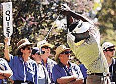 A marshall holds up a sign as Fiji's Vijay Singh tees off during his match against Kevin Sutherland from the USA at the World Matchplay Championship at the Metropolitan Golf Course in Melbourne on Wednesday.