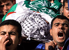 Palestinians carry the body of Mohammed Abu Haseera, chanting anti-Israeli slogans, during his funeral in Gaza on Saturday after he was shot by Israeli troops when he tried to cross the Israeli-Gaza border near an army post. 