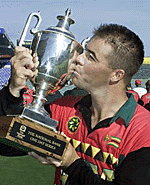 Zimbabwe cricket captain Heath Streak celebrates by kissing the National Bank One Day trophy 