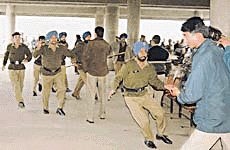 Security guards of Government Medical College, Chandigarh, attack a journalist outside �the emergency� on Tuesday. 