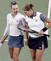 Switzerland�s Martina Hingis (left) and Monica Seles of the USA chat between points during their first round doubles match.