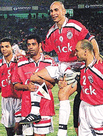 Egyptian veteran soccer striker Hossam Hassan is carried by his team-mates.