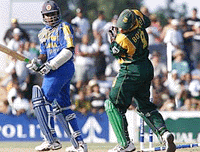 Sri Lankan batsman Mahela Jayawardene walks as South AFrican wicketkeeper Mark Boucher looks down at the fallen stumps during their third one day international on Tuesday.