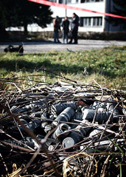 Health experts stand behind the line at a site with ammunition suspected of containing depleted uranium at Hadzici, Bosnia on Wednesday. In the wake of the Balkans Syndrome, several NATO countries have asked it to ban the use of depleted uranium weapons. 