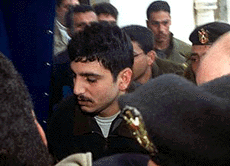 Allan Bani Odeh is escorted by Palestinian policemen on the way to his execution by firing squad from the Nablus preventive security headquarters to the Nablus police station, on Saturday