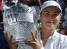 Switzerland�s Martina Hingis holds her trophy after defeating Lindsay Davenport of the USA in the women�s singles final at the Sydney International at Homebush Bay.