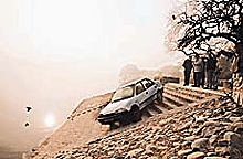 Car wash at an unlikely place: This car rolled down the steps of Sukhna Lake.