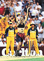Intruder Peter Hore (C) dances on the pitch while being watched by Australian cricketers Mark Waugh (L) and Shane Warne (R) during the one-day international between Australia and the West Indies at the Sydney.