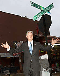 US President Bill Clinton poses in front of a street sign bearing his name in Little Rock on Wednesday. Mr Clinton was on the final trip of his presidency, a sentimental journey back to his home state of Arkansas. The street named after Mr Clinton will be near his presidential library.