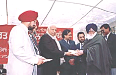The Punjab Minister for Labour and Employment, Mr Balramji Dass Tandon, (centre), at a function to mark the first Lok Adalat for labour cases, in Ludhiana on Friday. 