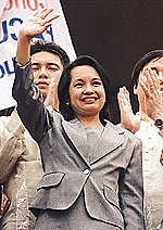 Gloria Arroyo waves to the crowds after being sworn in as the new President of the Philippines.