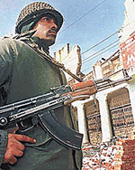 An Indian para-military trooper keeps a strict vigil at Palladium Chowk in the central Srinagar, the summer capital of Jammu and Kashmir in India on Tuesday.
