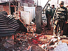 Paramilitary jawans stand near the site of an explosion at Dalgate in the heart of Srinagar on Wednesday.