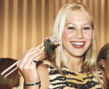 Russian tennis player Anna Kournikova smiles as she shows off her chopstick skills at a welcoming reception for the $1,188,000 Pan Pacific Open tennis tournament at a Tokyo hotel on Monday.