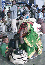 Villagers fleeing earthquake-stricken areas in Gujarat wait for trains at Ahmedabad�s main railway station on Tuesday.