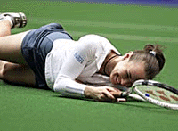 Martina Hingis of Switzerland slips on the court after returning a shot against Ai Sugiyama of Japan during their quarter-final match at the Pan Pacific Open Tennis Tournament in Tokyo on Friday.