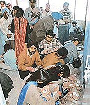 Students of Punjab School Education Board and their parents sort out roll-number cards at the office of a private courier company in Sector 22, Chandigarh, on Friday. 
