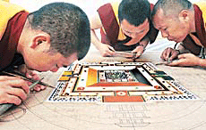 Monks of Namgyal Monastery, Dharamsala, make a Kal Chakra Mandala at the Tibetan festival in DAV Model School, Sector 15, Chandigarh, on Friday. 