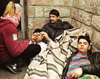 Indian immigrants lie after 14 days of their hunger strike in Santa Maria del Pi church in central Barcelona on Friday.