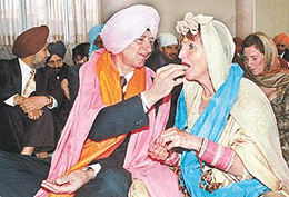 Mike and Brenda, newly married Canadian couple, share sweets at the Sector 46 Gurdwara, where they got married according to Sikh rites. 