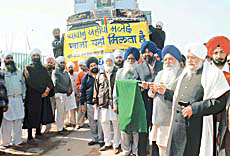 A convoy of trucks carrying relief material for earthquake victims being flagged off by Sant Waryam Singh at Ratwara Sahib Gurdwara on Sunday.