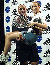 World number one tennis player Martina Hingis is lifted up by New Zealand's All Blacks rugby star Johah Lomu during a news conference in Tokyo on Monday. 