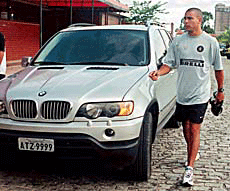 Brazilian Inter Milan striker Ronaldo walks past his sports utility BMW after training in Rio de Janeiro on Monday. 