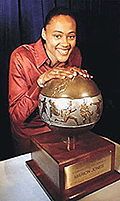 Marion Jones, the first woman to win five track and field medals at an Olympics, poses with the 21st annual Jesse Owens International Trophy in New York on Thursday.