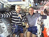 Commander Ken Cockrell (left) and astronaut Tom Jones answer questions during a televised interview with various journalists of earth from Atlantis�s flight deck on Thursday. 