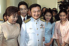 Thailand�s new Prime Minister Thaksin Shinawatra (centre) and his family pose for group pictures after he received a royal decree from King Bhumibol Adulyadej appointing him as Prime Minister in Bangkok on Friday. 