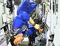 Cosmonaut Sergei Krikalev floats upside down in the Zveda module of the International Space Station in this view from television on Friday.