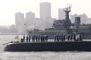 Sailors from the Indian Navy stand on a submarine as Indian and foreign warships began to line up off the Mumbai coast on Wednesday ahead of the International Fleet Review scheduled for February 17. 