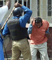 A Bangladeshi policeman beats an Opposition activist in Dhaka during a nationwide strike on Thursday.